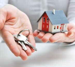 Real Estate Agent with House Model and Keys