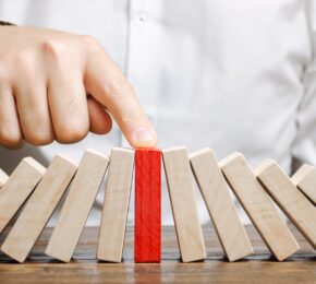 Business Man Stops Collapse Domino Effect